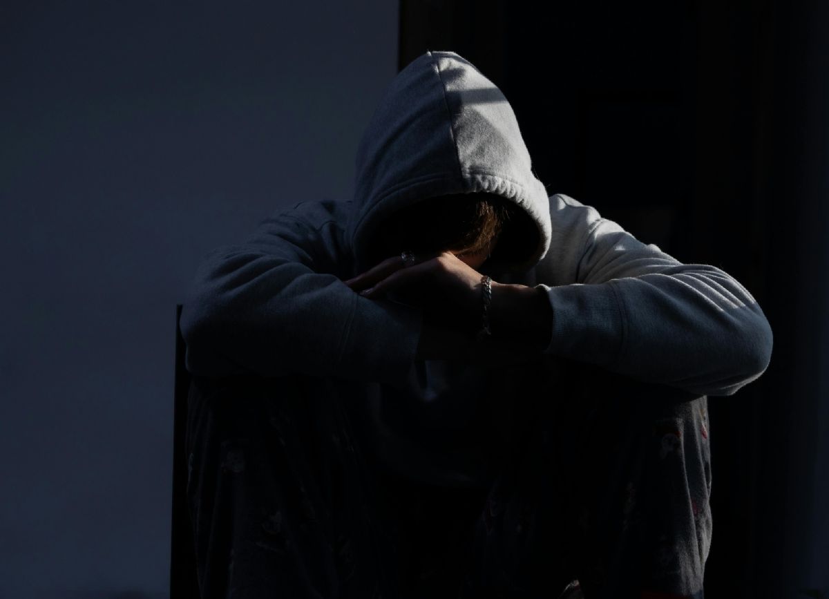 Worried Teen sitting on the floor.