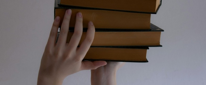 Hands holding books
