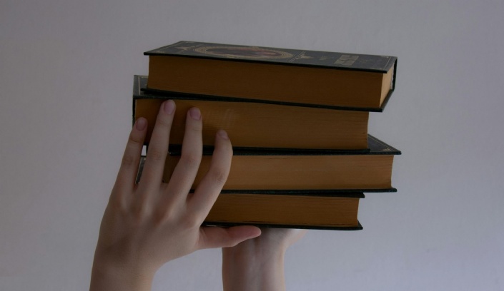 Hands holding books